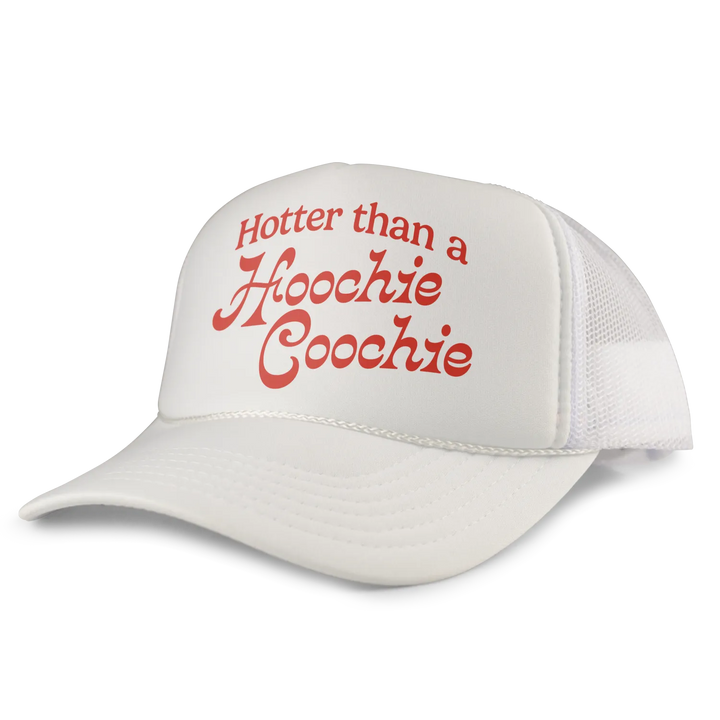 White trucker hat with red cursive text reading ’hotter than a hoochie coochie’ on the front panel.