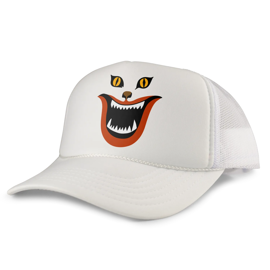 White trucker hat featuring a cartoon cat face with yellow eyes, an orange mouth, and sharp teeth.