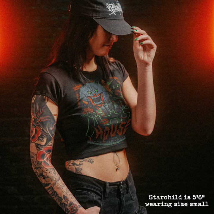 Female model wearing cropped baby tee with house graphic
