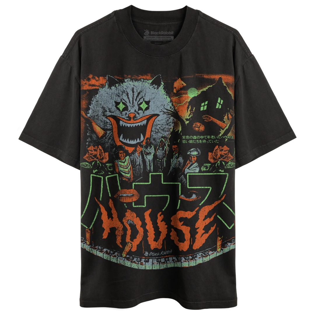 Black t-shirt with a colorful, detailed graphic print featuring a cat-like monster, a haunted house, and other elements in an eerie, vibrant style.