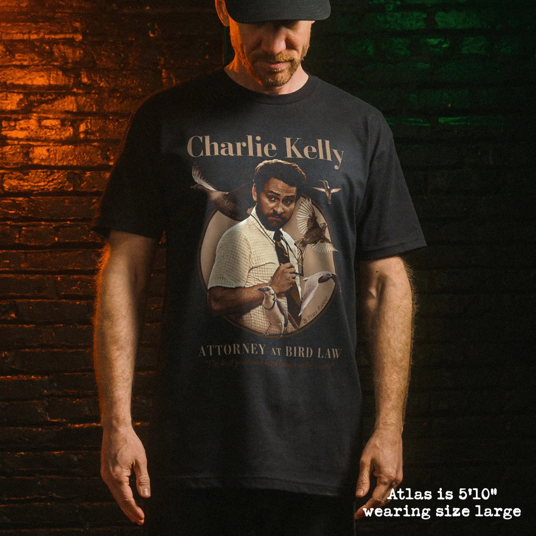 Male model wearing black premium tee with charlie bird law graphic 