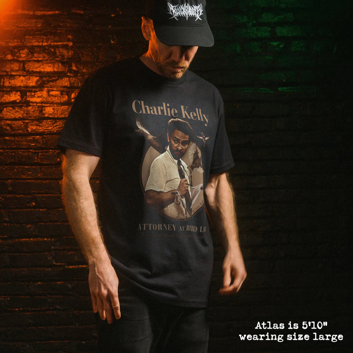 Male model wearing black premium tee with charlie bird law graphic 