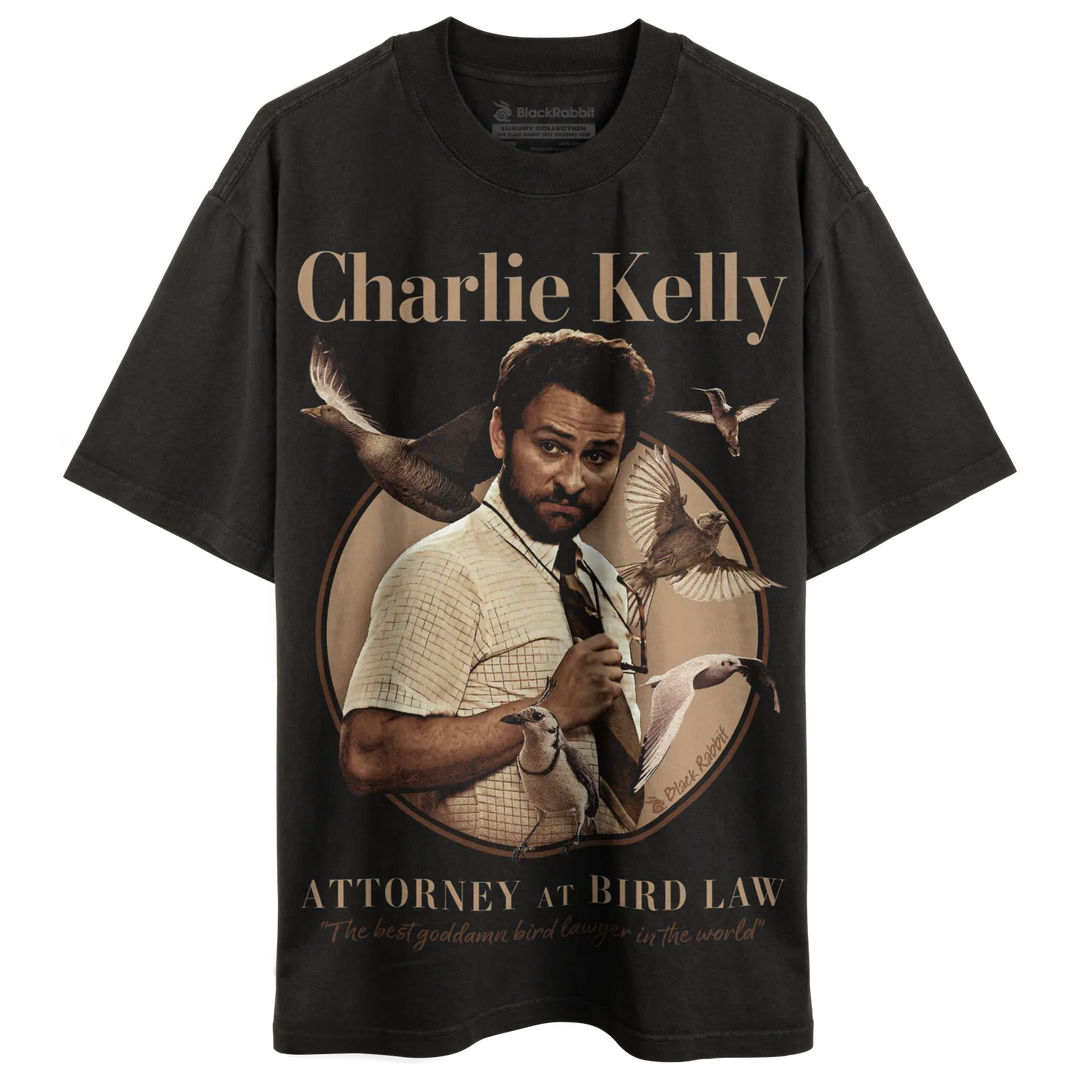 Black t-shirt with charlie kelly graphic and text ’attorney at bird law’ in gold. 