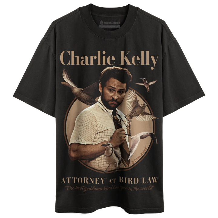 Black t-shirt with charlie kelly graphic and text ’attorney at bird law’ in gold. 