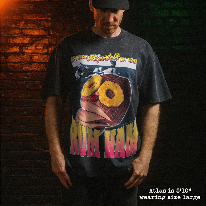 Male model wearing heavy stone washed tee with rum ham graphic. 