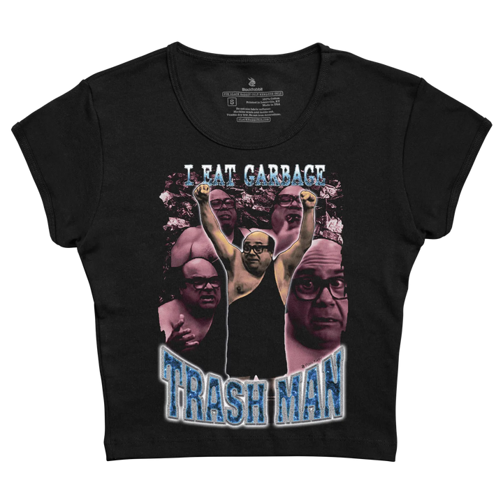 Black cropped t-shirt featuring a graphic print of the character trash man with raised fists and surrounding faces, overlaid with ’i eat garbage’ in white text above and ’trash man’ in blue distressed lettering below.
