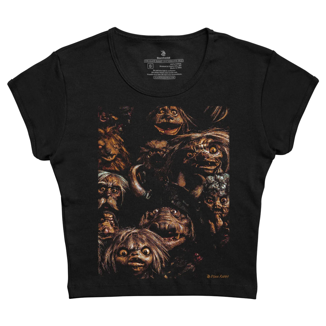 Black short-sleeved t-shirt featuring a detailed, dark-toned graphic of multiple grotesque, hairy faces with wide eyes and varied expressions.