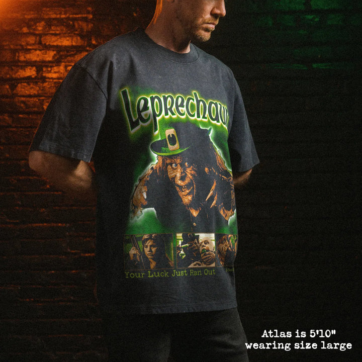 Male model wearing stone wash heavy tee with leprechaun graphic 