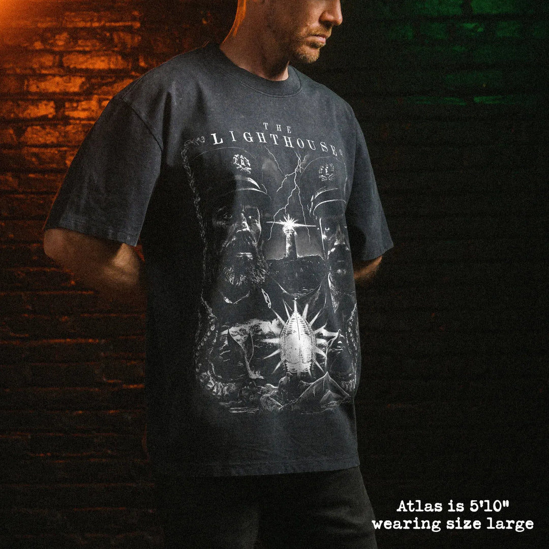 Male model wearing stone wash heavy tee with lighthouse graphic 