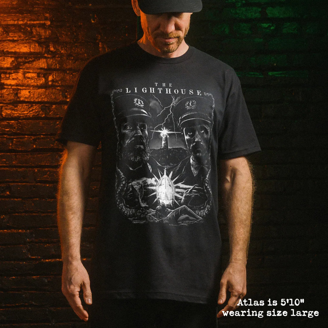 Male model wear soft premium tee with lighthouse graphic
