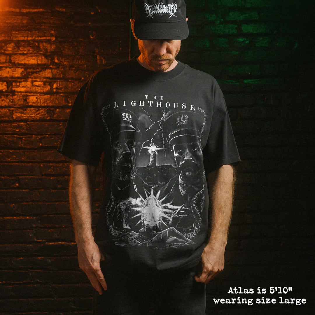Model wearing heavy tee with lighthouse graphic 
