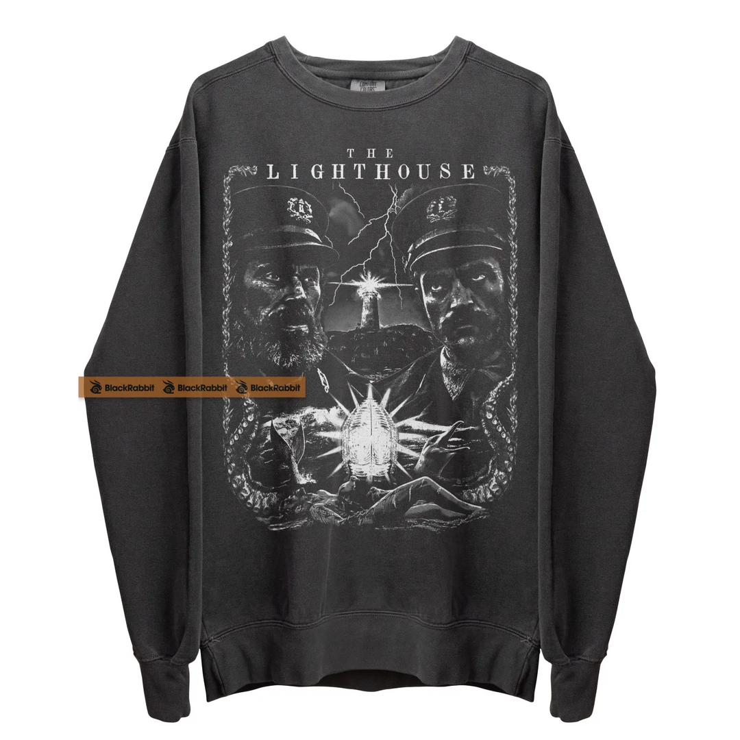 Gray sweatshirt with ’The Lighthouse’ graphic.