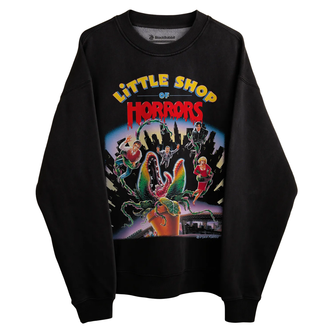 Black sweatshirt with ’little shop of horrors’ graphic design featuring a plant and characters. 