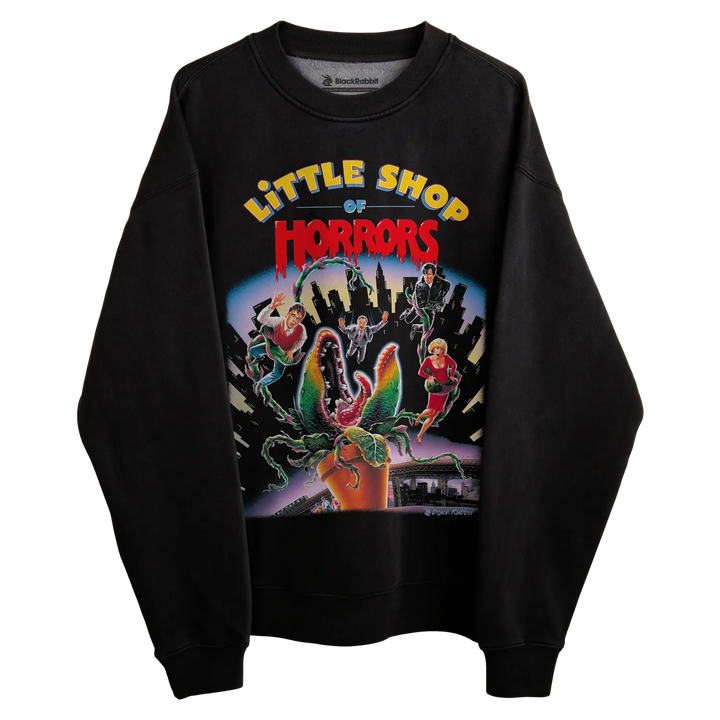 Black sweatshirt with ’little shop of horrors’ graphic design featuring a plant and characters. 