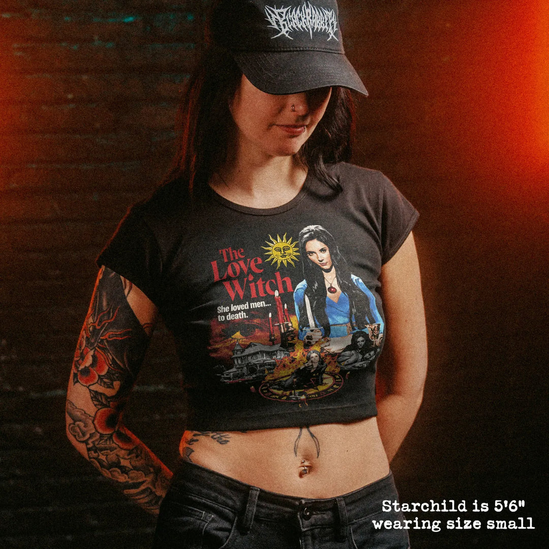 Female model wearing cropped baby tee with love witch graphic
