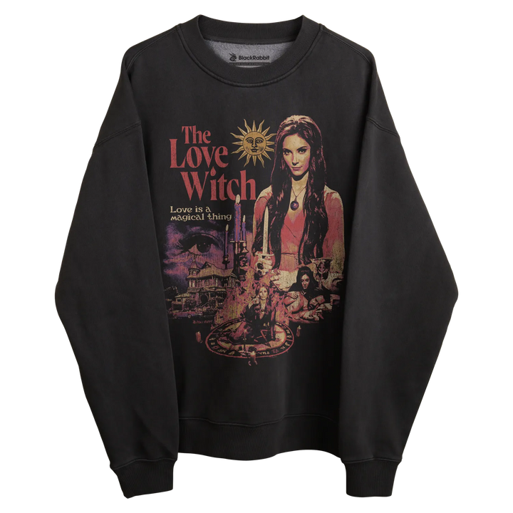 Black sweatshirt with ’the love witch’ graphic design featuring a woman and sun motif, likely cotton or polyester blend.