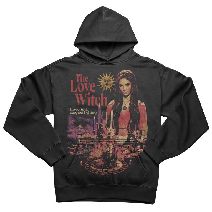 A dark grey hooded sweatshirt with a vibrant graphic print of a woman, a sun, and the phrase ’The Love Witch’ on the front.