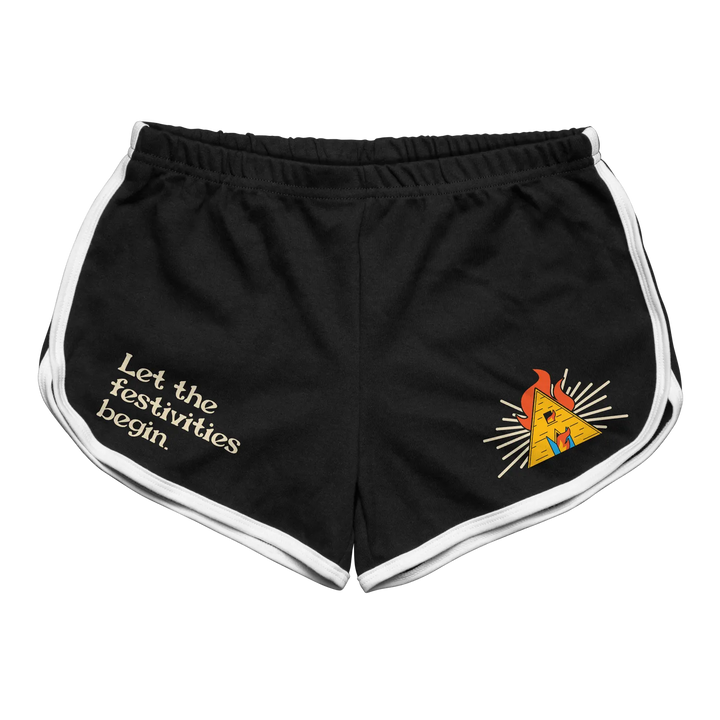 Black athletic shorts with white trim and a yellow pyramid graphic on the left leg, featuring the text ’let the festivities begin’ in cream-colored lettering.