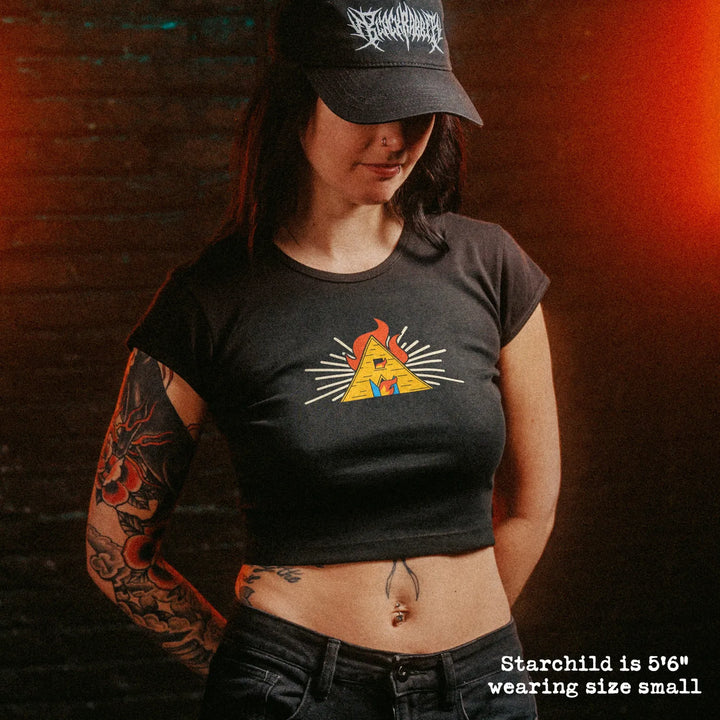 Female model wearing cropped baby tee with midsommar hut graphic
