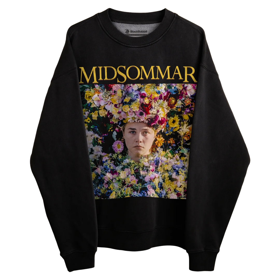 Black sweatshirt with floral design and ’midsommar’ text in gold.