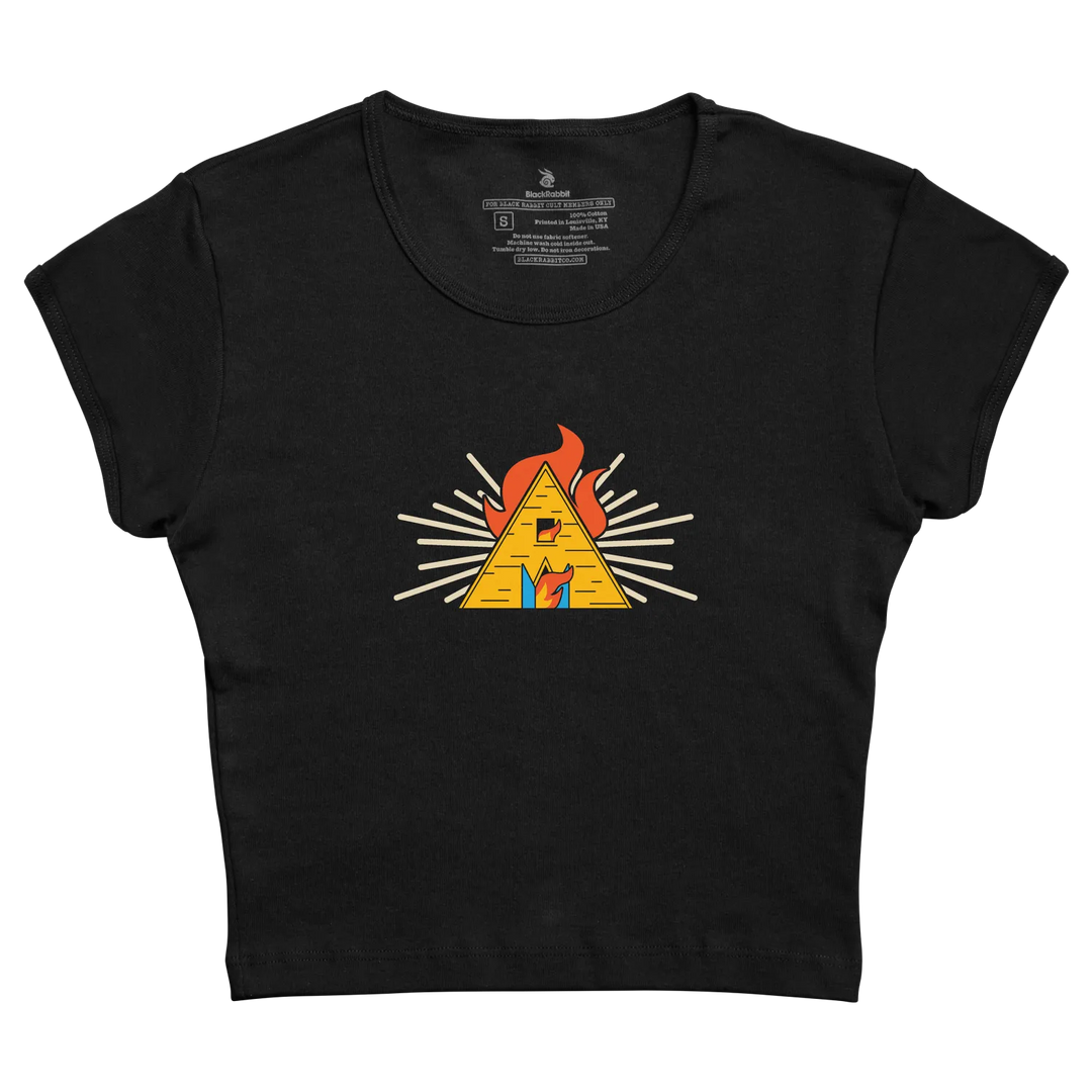 Black cropped t-shirt featuring a vibrant yellow pyramid with orange flames and white radiating lines across the chest.