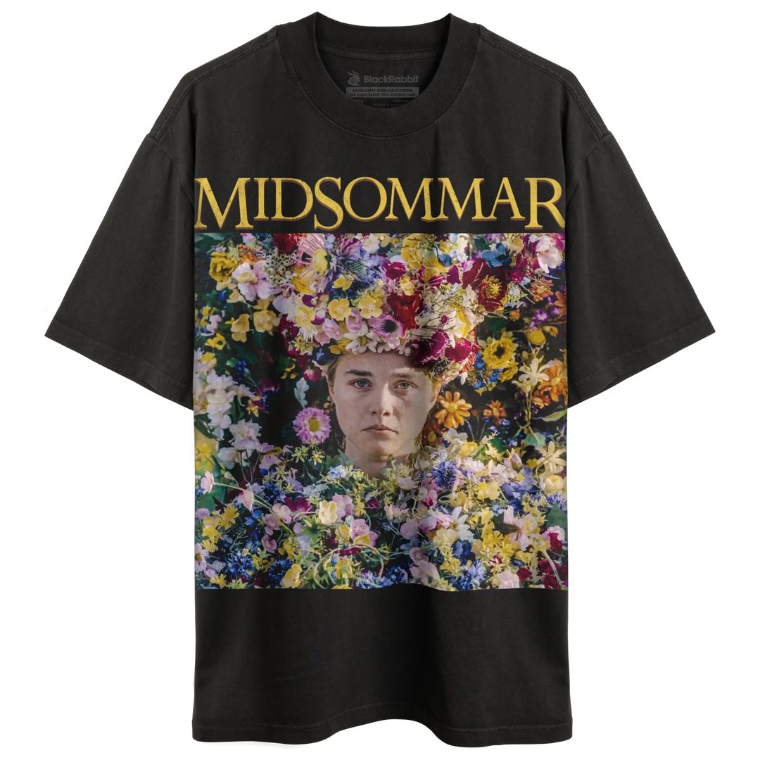 Black short-sleeved t-shirt with a colorful floral graphic and the word ’MIDSOMMAR’ in yellow.