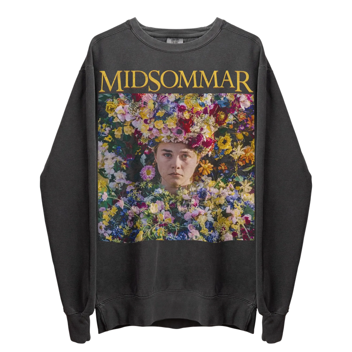 Dark gray crewneck sweatshirt featuring a colorful graphic of a woman’s face surrounded by a vibrant floral arrangement, with ’MIDSOMMAR’ in yellow text above.