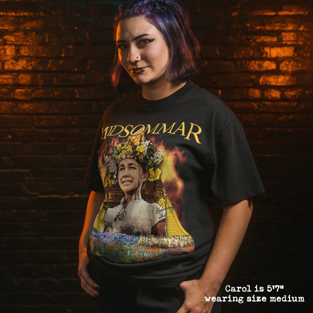 Model wearing heavy tee with midsommar fire hut graphic 