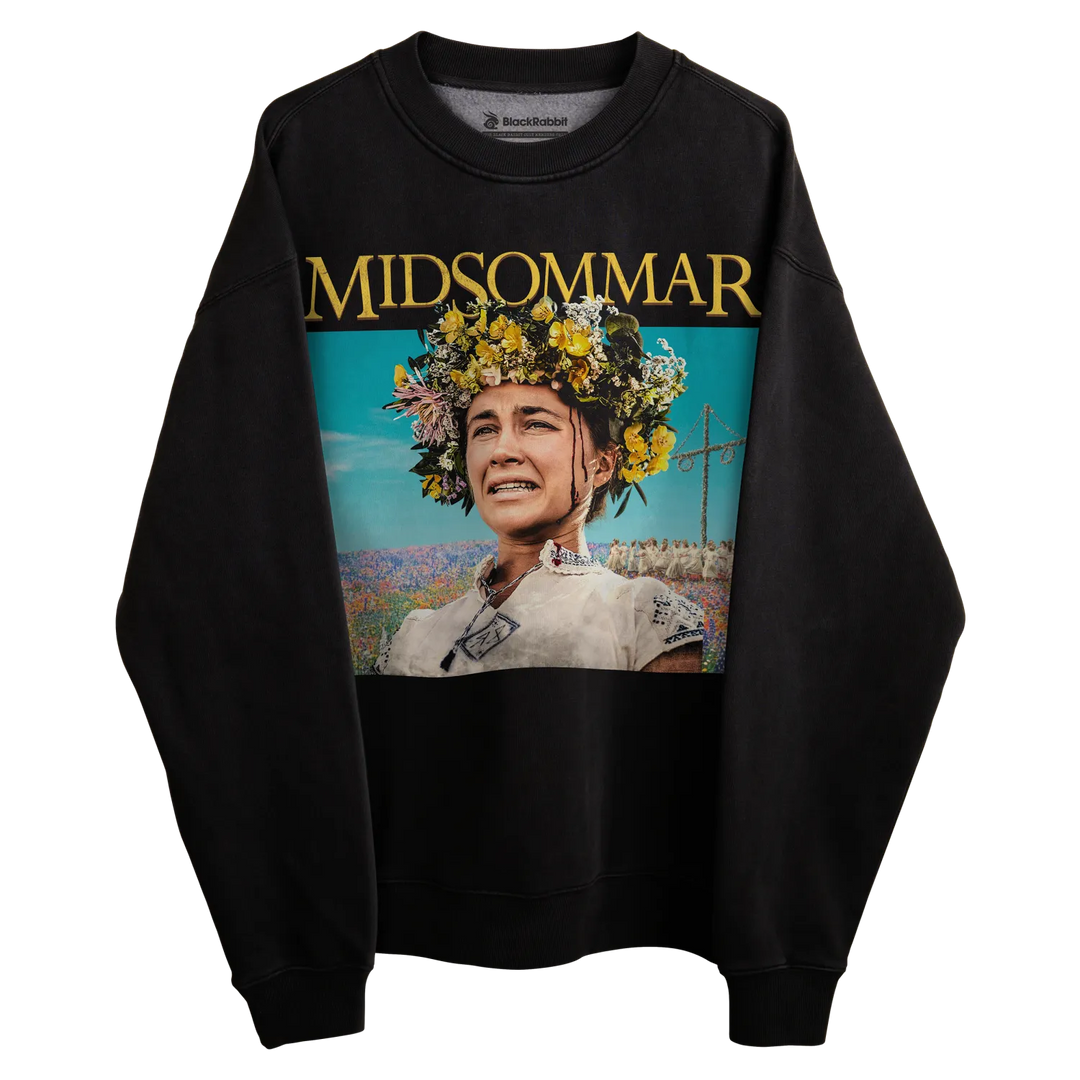 Black sweatshirt with ’midsommar’ graphic design featuring a woman in floral crown and pastoral landscape.