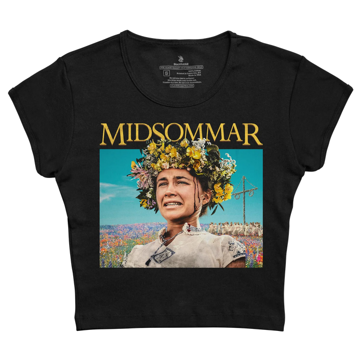 Black cropped t-shirt featuring a printed graphic of a woman with a floral crown and the word ’midsommar’ in gold lettering above it.