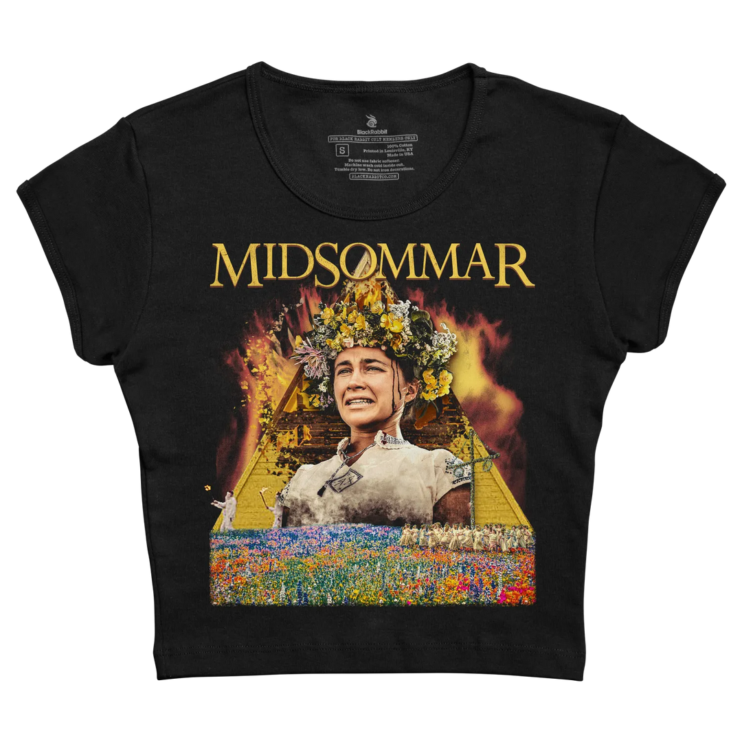 Black short-sleeved t-shirt featuring a graphic print of the movie ’midsommar’ with golden text and an image of a woman in a floral crown against a fiery, colorful background.