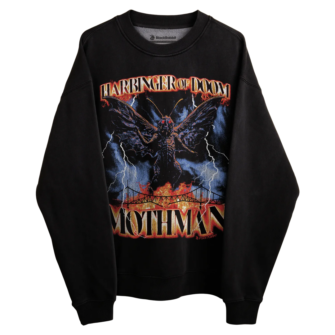 Black mothman sweatshirt with vibrant graphic design featuring a dark creature and fiery background.