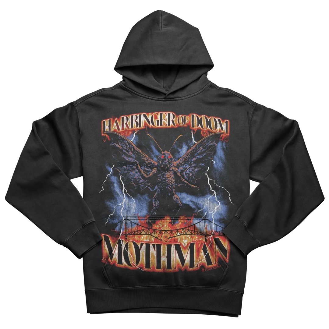 A black hooded sweatshirt with a graphic print of a winged creature, lightning, and a bridge over flames.