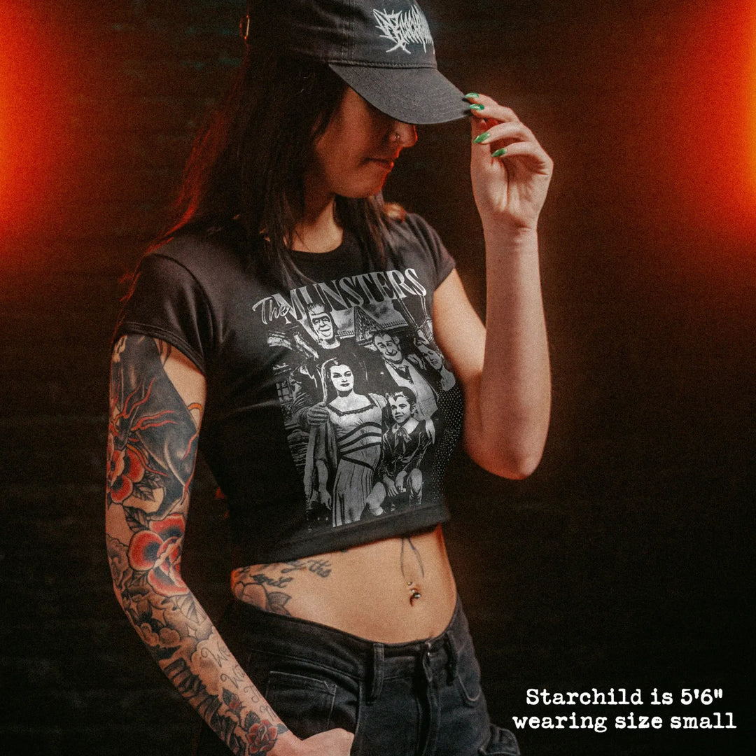 Female model wearing cropped baby tee with munsters graphic
