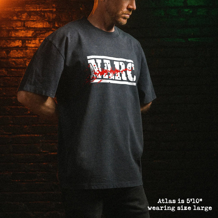 Male model wearing stone wash heavy tee with NARC graphic 