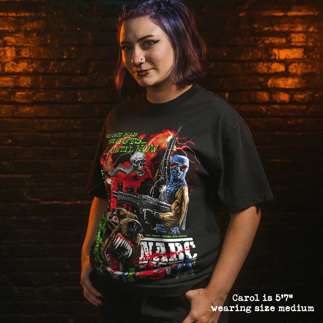 Female model wearing Black Rabbit Oversized Luxury Heavy Tee in Faded Black with NARC print. She is 5'7" and wearing a size medium.