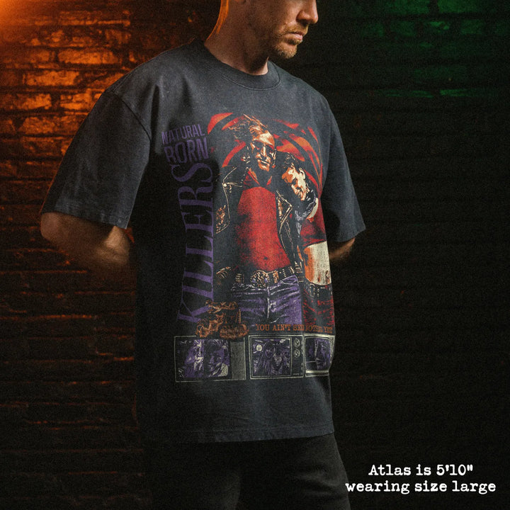 Male model wearing stone wash heavy tee with natural born killers graphic 