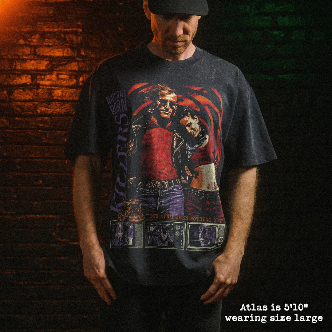 Male model wearing heavy stone washed tee with natural born killers graphic. 