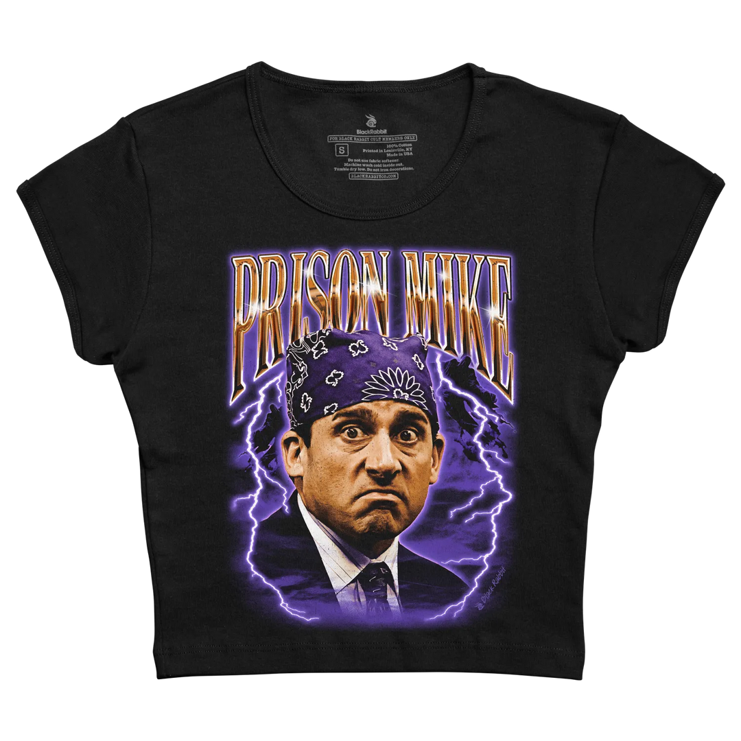 Black short-sleeved t-shirt featuring a vibrant graphic of prison mike from the office, surrounded by purple lightning bolts and bold gold lettering.