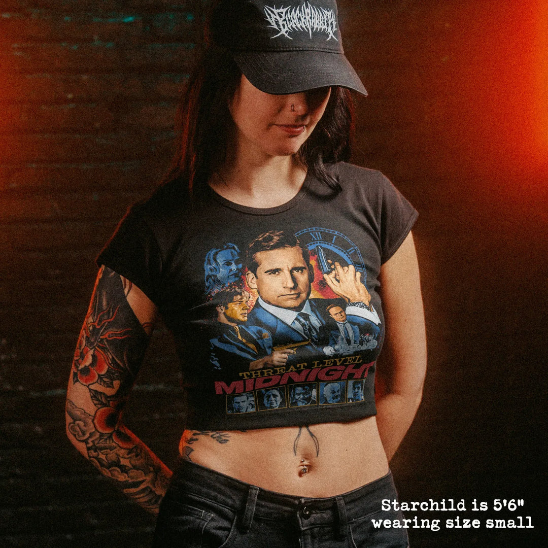 Female model wearing cropped baby tee with threat level midnight graphic
