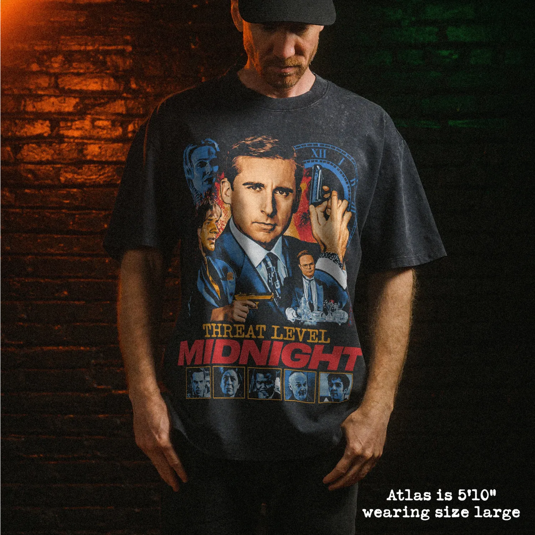 Male model wearing heavy stone washed tee with threat level midnight graphic. 