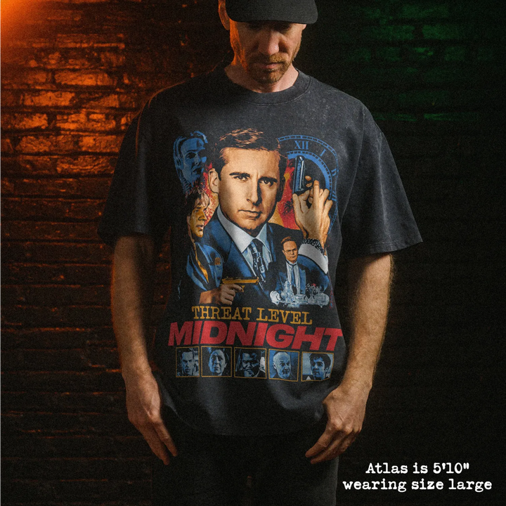Male model wearing heavy stone washed tee with threat level midnight graphic. 