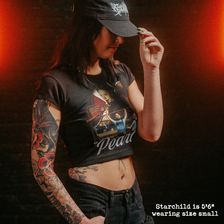 Female model wearing cropped baby tee with pearl graphic
