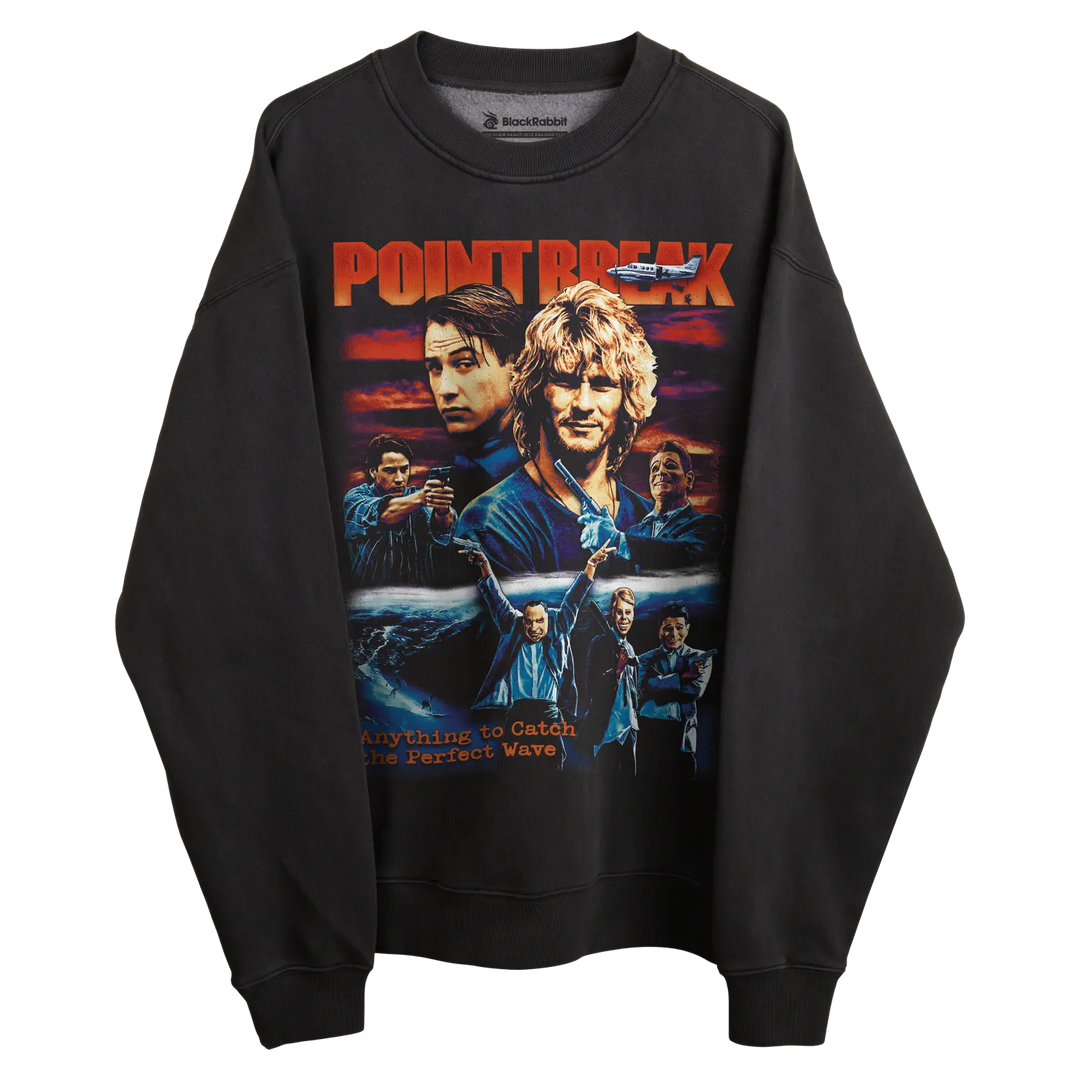 Black crewneck sweatshirt with ’point break’ graphic design featuring characters and title in bold, vibrant colors.