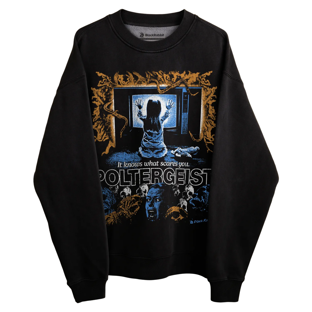 Poltergeist sweatshirt with ghostly design and text ’it leaves what scares you’ in white on black background.