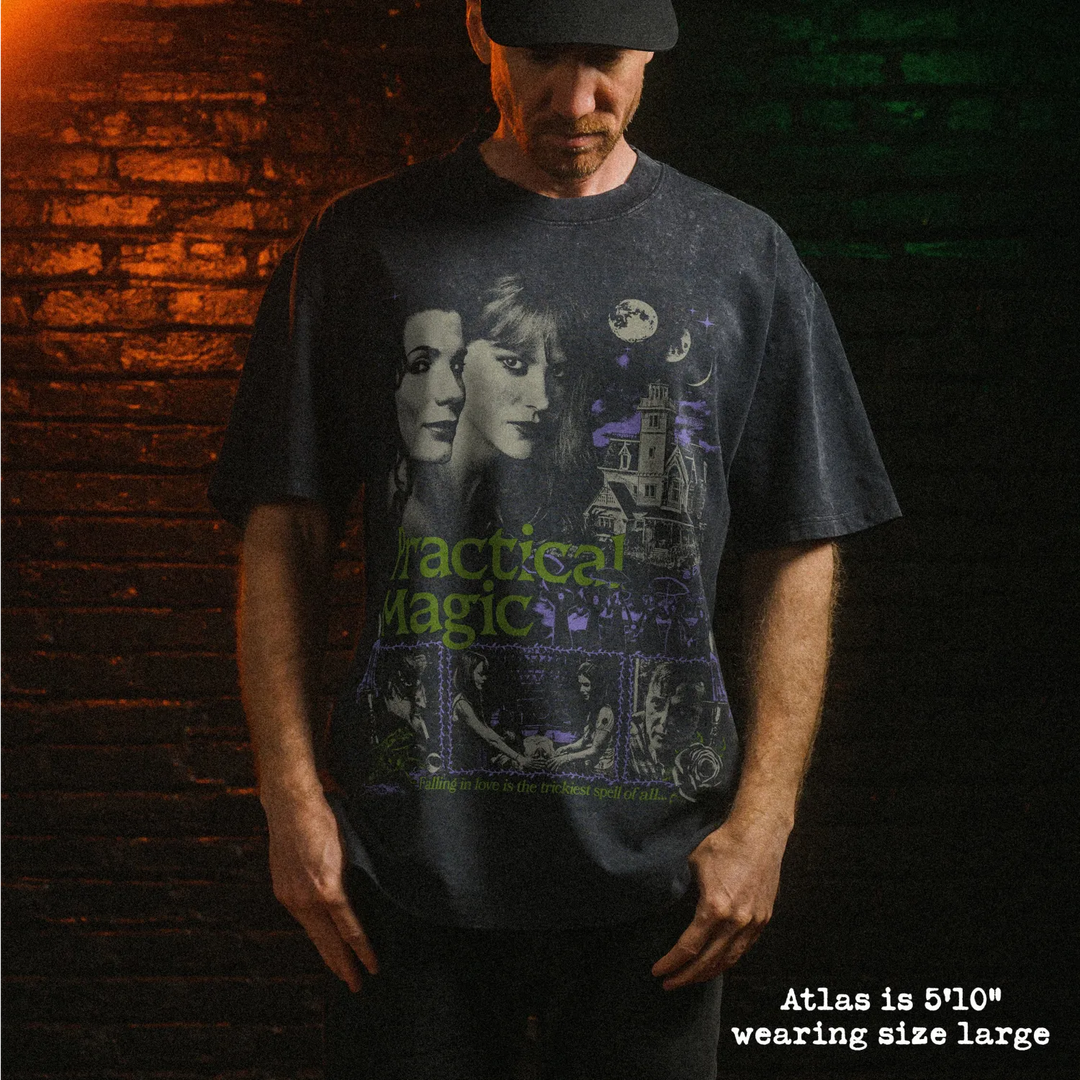 Male model wearing heavy stone washed tee with practical magic graphic. 