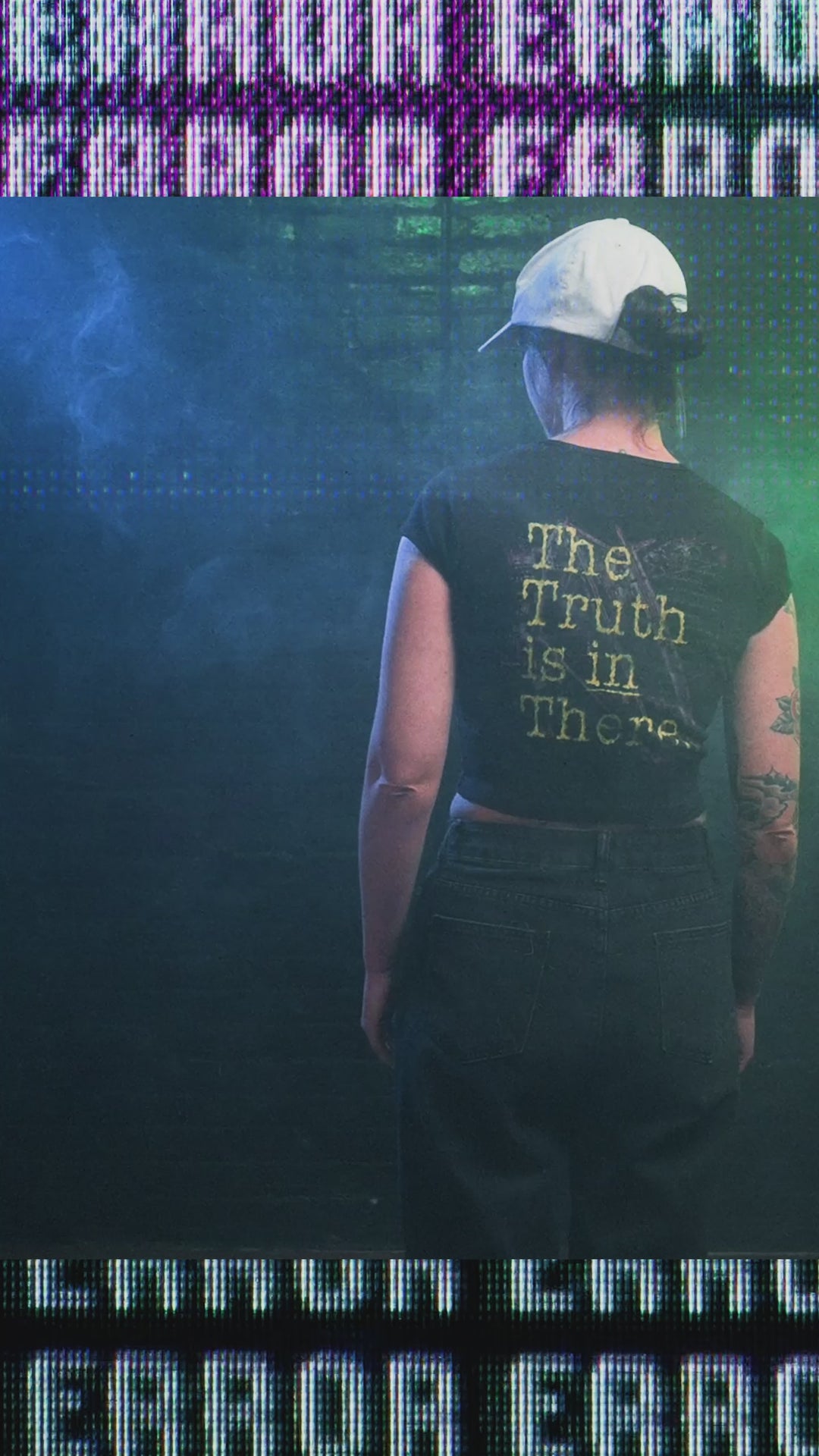 Female model wearing cropped baby tee with area 51 graphic
