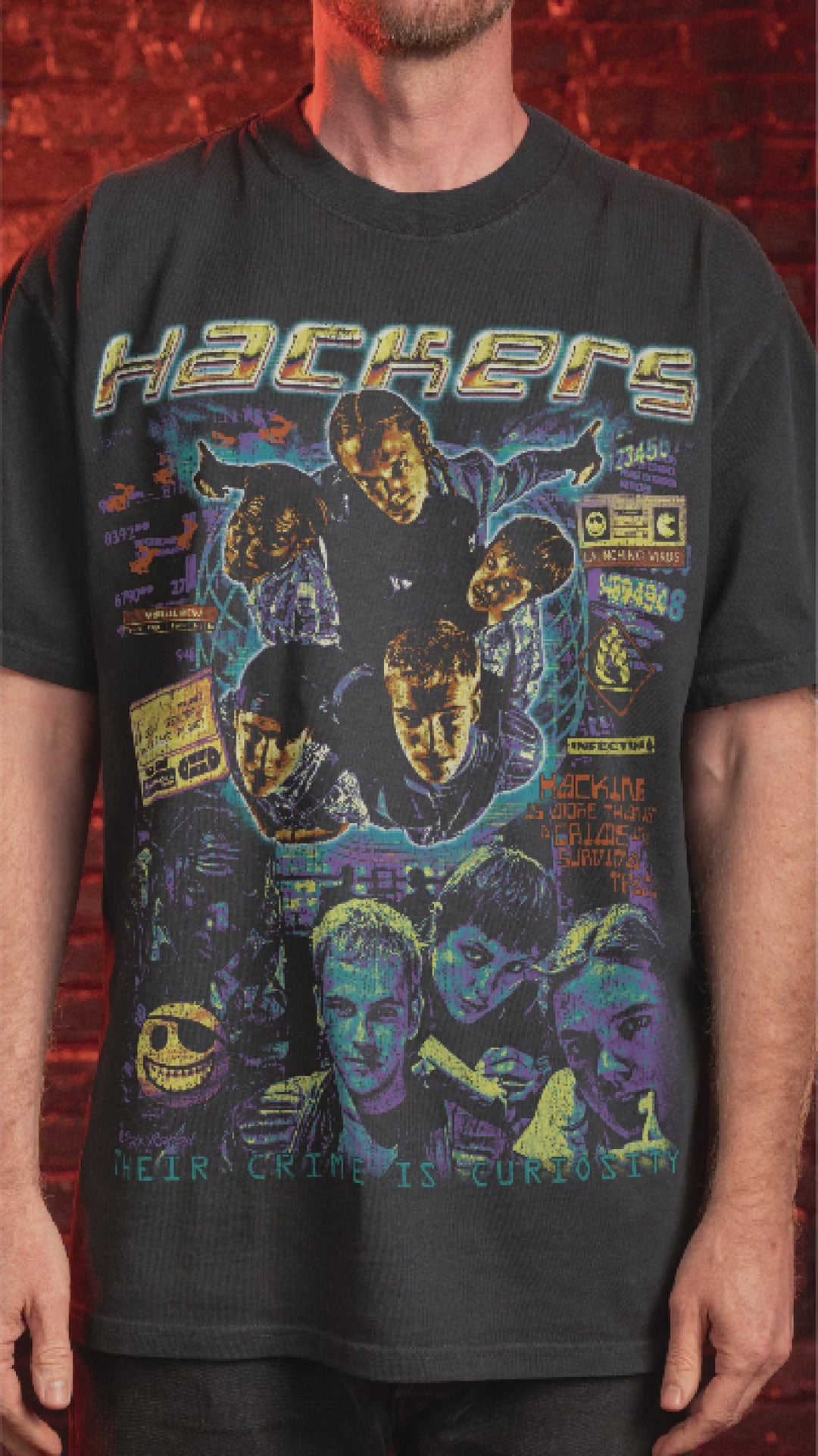 Black short-sleeved t-shirt with a colorful ’Hackers’ movie graphic print. 