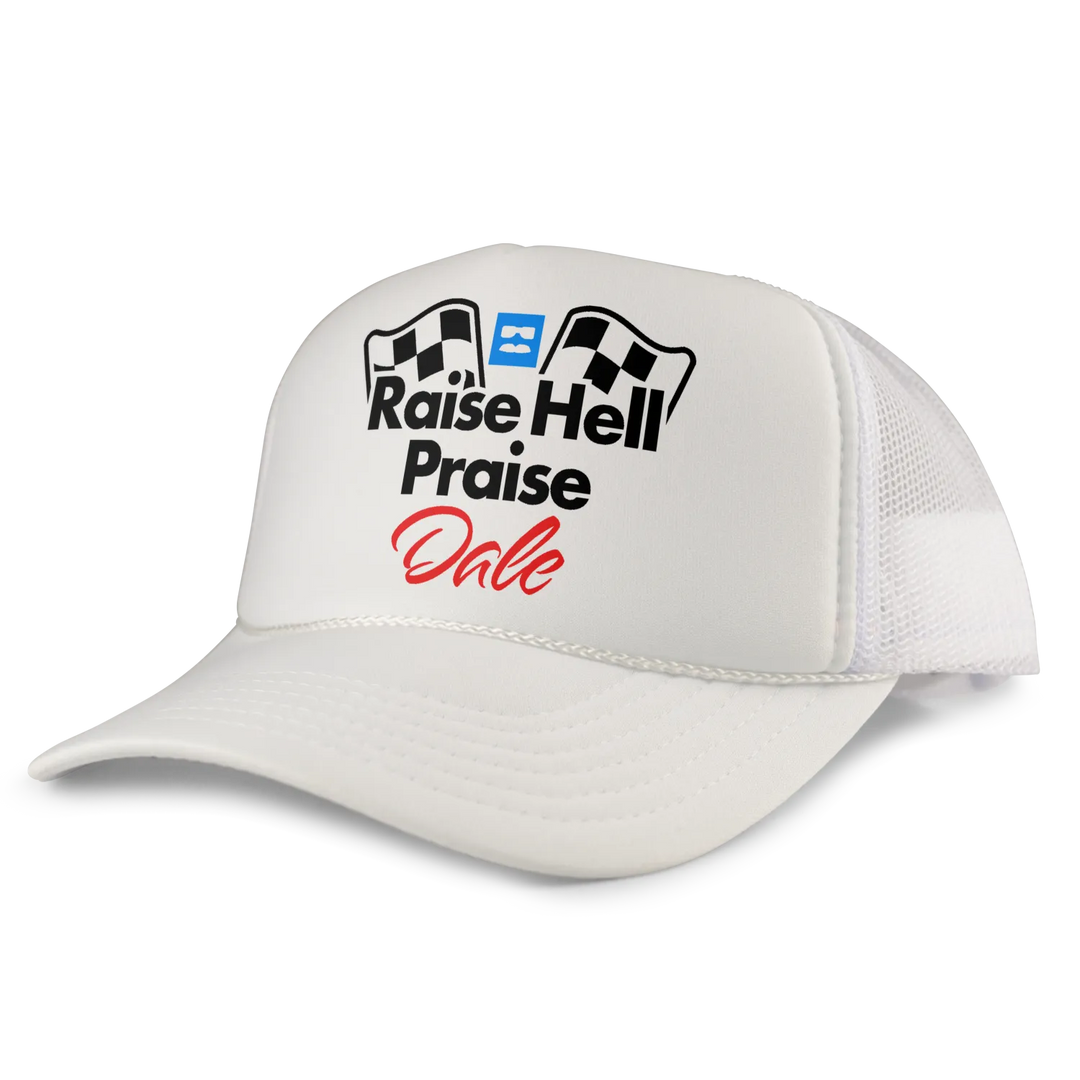 White trucker hat with black and red graphic reading ’raise hell praise dale’ flanked by checkered flags.