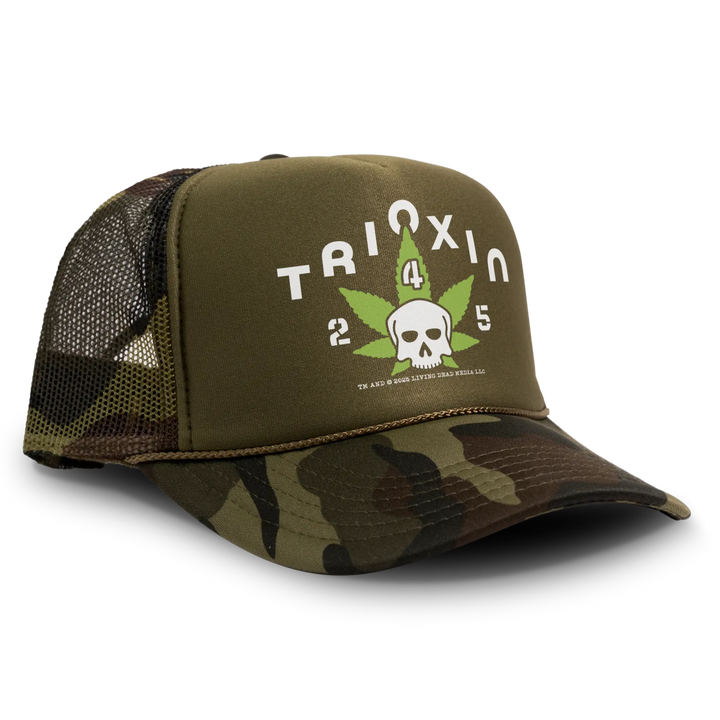 Camo trucker hat with skull and marijuana leaf design.